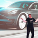Elon Musk in front of a Tesla in Shanghai.